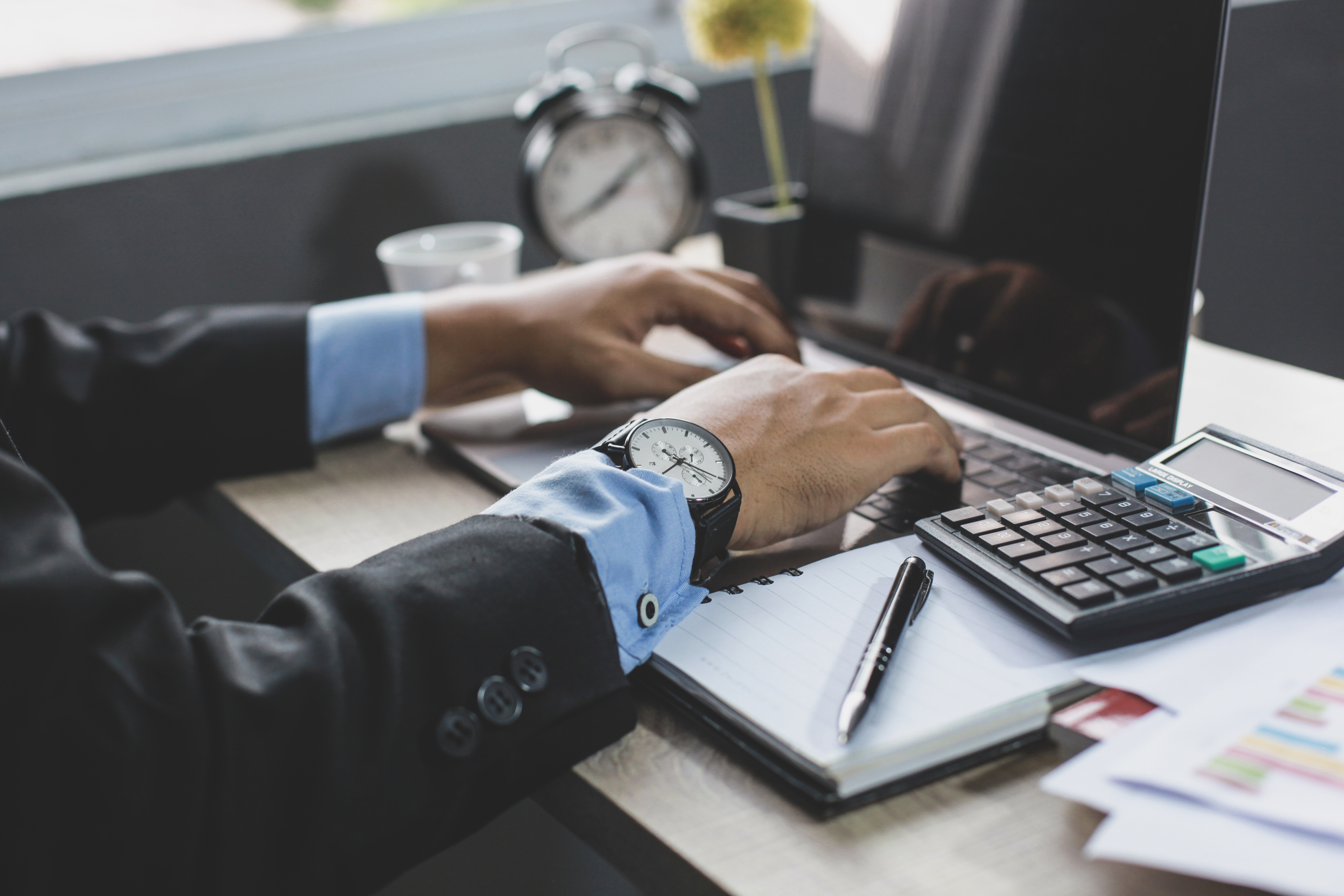 businessman-using-laptop-on-office-desk-2026-01-07-05-37-20-utc