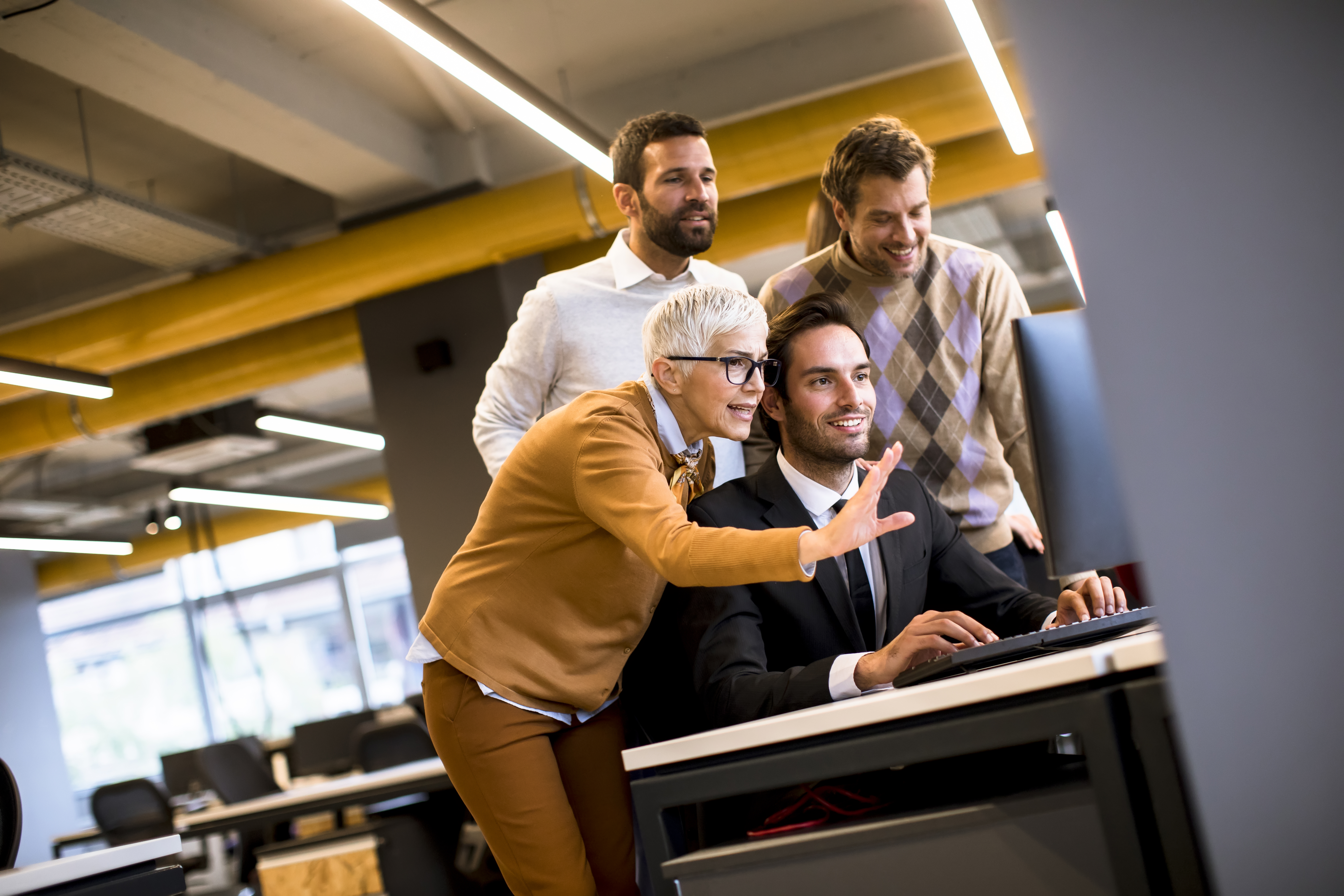 Senior businesswoman working together with young business people